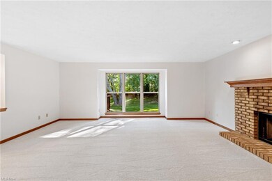 Living room featuring a fireplace and light carpet