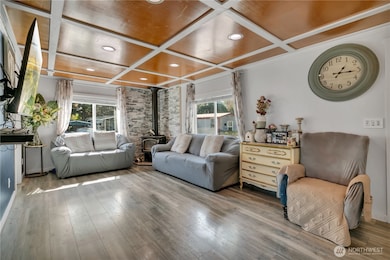 Cozy wood stove and large windows bring warmth and light.