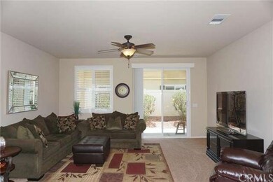 Living room with plantation shutters, slider to co