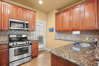 Kitchen with stainless steel appliances, a sink, 