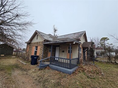 View of front of home with a front yard and covere