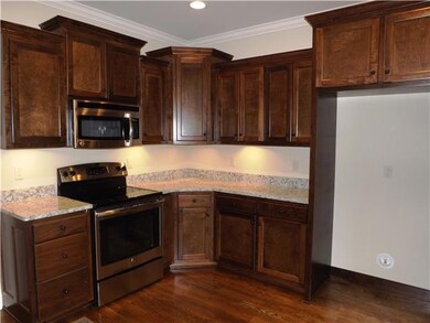 The beautiful cabinetry is custom with stacked design, crown molding and under mount lighting.