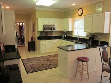 The spacious kitchen has granite counter tops, ton
