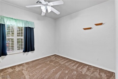bedroom 1 with carpet, ceiling fan/light and plantation shutters, mirrored closet door