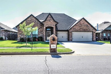 View of front of house with a garage and a front y