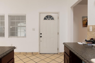 Entrance foyer with light tile patterned floors