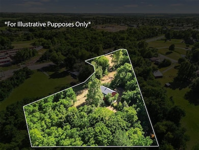 Aerial view of property's location featuring property parcel outlined and a forest