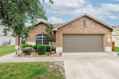 Ranch-style home with brick siding, concrete driveway, and stone siding