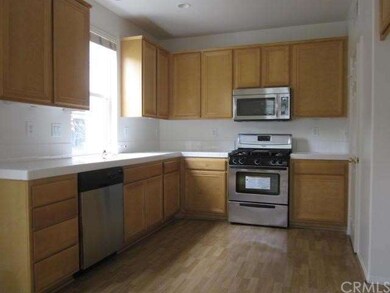 Spacious kitchen with laminate flooring, new paint