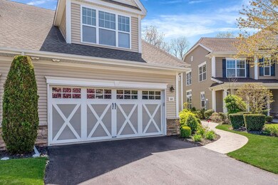 View of front of property featuring a garage, a sh
