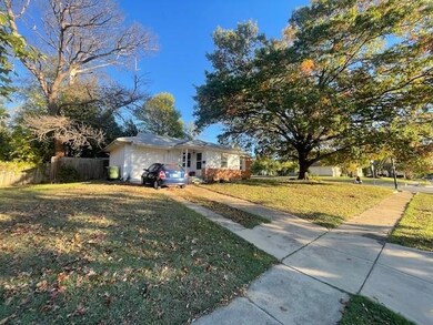 Single story home featuring a front yard and a gar