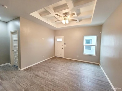 Kitchen view of light stone counters and a sink