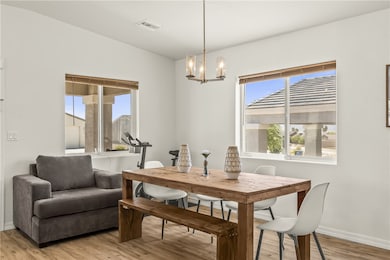 Dining area featuring light wood finished floors and a chandelier