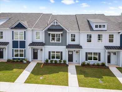 Multi unit property with a standing seam roof, board and batten siding, and a front yard