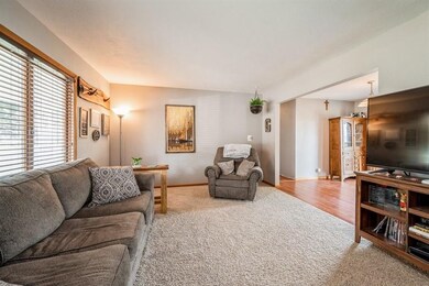 Spacious living room area with neutral carpet