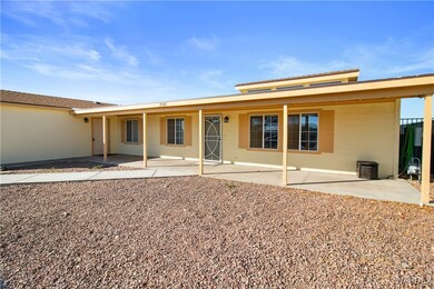 Front view of house with a covered patio and stucc