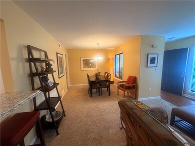 Dining area with carpet floors and baseboards