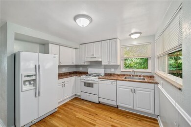 Timeless white cabinets in the kitchen & fresh hardwood floors!