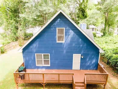 Rear view of house featuring a deck