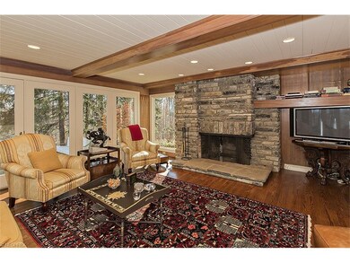 The original, rustic stone fireplace is a focal po