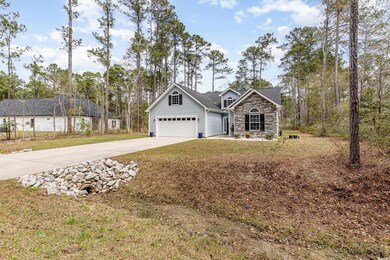 View of front of house featuring driveway, a garag