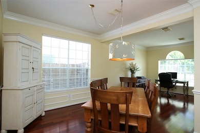 Centrally located formal dining keeps social meals connected to adjacent rooms, such as the den and kitchen.