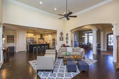 Open Floor Plan. View Across Great Room into Kitchen, Dining, & Entry.