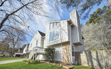 View of home's exterior featuring a chimney and stone siding