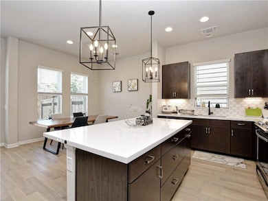 Kitchen featuring a sink, light wood-type floorin