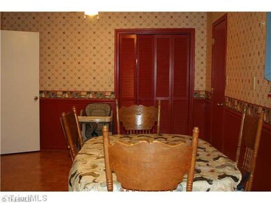 Cafeteria/Kitchen. Large dining area.  Doors straight ahead lead to the washing machine/dryer that is staying. Door to right leads to large pantry.  Door to left leads to livingroom area and hallway to bedrooms.