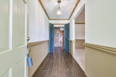 View through the frond door leading to the formal living area and den area.