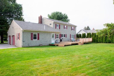 Rear exterior view with lawns and deck