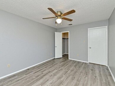 Unfurnished bedroom with wood finished floors, ba