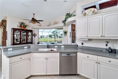 Kitchen has raised faced cabinetry & breakfast bar