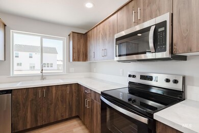 Kitchen with appliances with stainless steel finishes, light countertops, light wood-style flooring, recessed lighting, and modern cabinets