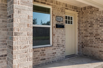 Entrance to property with brick siding