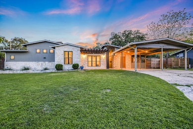 View of front facade featuring a yard, fence, sto