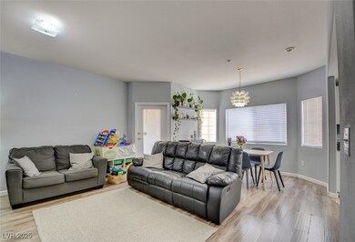 Living room with light hardwood / wood-style floor