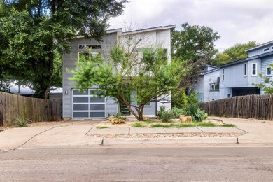 View of front of house featuring fence, concrete 