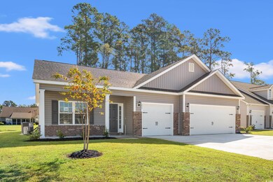 Craftsman-style house with a garage and a front ya