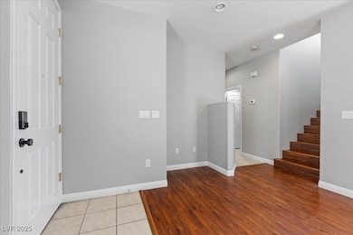 Foyer entrance with stairs, baseboards, recessed l