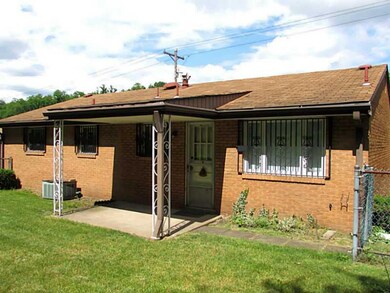 Exterior Back. It sits on a Nice Lot and is conven