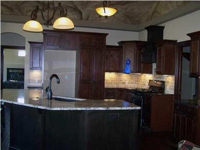 Kitchen with faux painted barrel ceiling, island, 