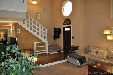 Front door entry with hardwoods opens to the vault