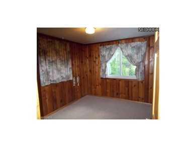 Bedroom #2 with knotty pine walls and radiant heat