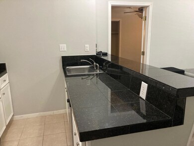 Bathroom with tile patterned floors, baseboards, 