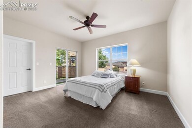 Sunny primary bedroom with patio