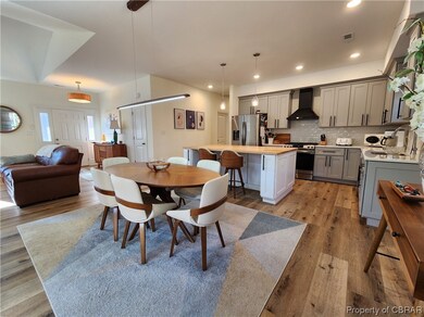 Dining area with light wood-type flooring and sink