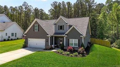 Craftsman inspired home with fence, a shingled roo