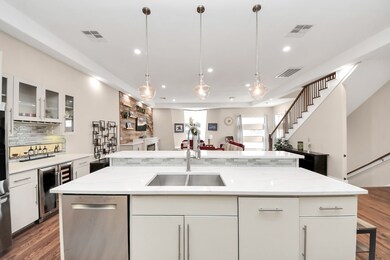 This sleek kitchen features a breakfast bar for co